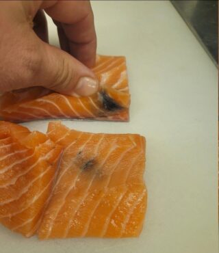 I bought salmon a week ago and wanted to make it for dinner today. When I took it out of the refrigerator, it had a yellow stain on it. What is it?